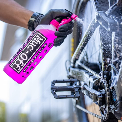 Muc-Off - Bike Cleaner (1 Litre) lifestyle photo spraying the cleaner