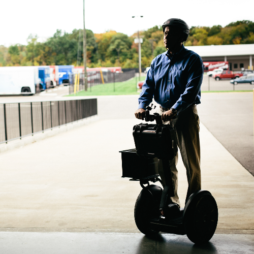 Segway Personal Transporter in black, displayed in a city background, to showcase the product being used for Security purposes