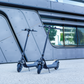 Two NIU - KQi100F Electric KickScooters in a lifestyle photo on the street