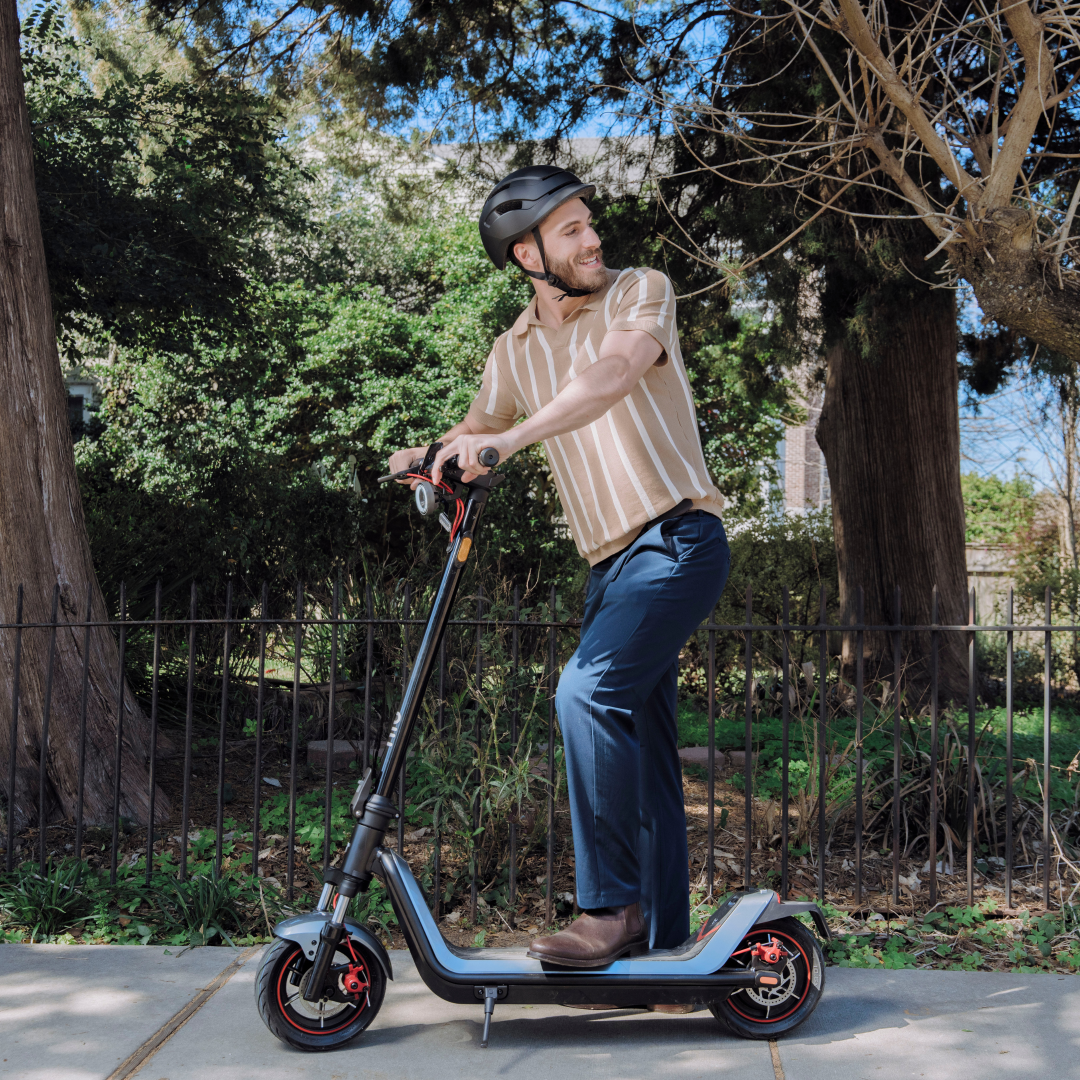 NIU KQi300X Electric KickScooter lifestyle photo of consumer taking the scooter for a ride