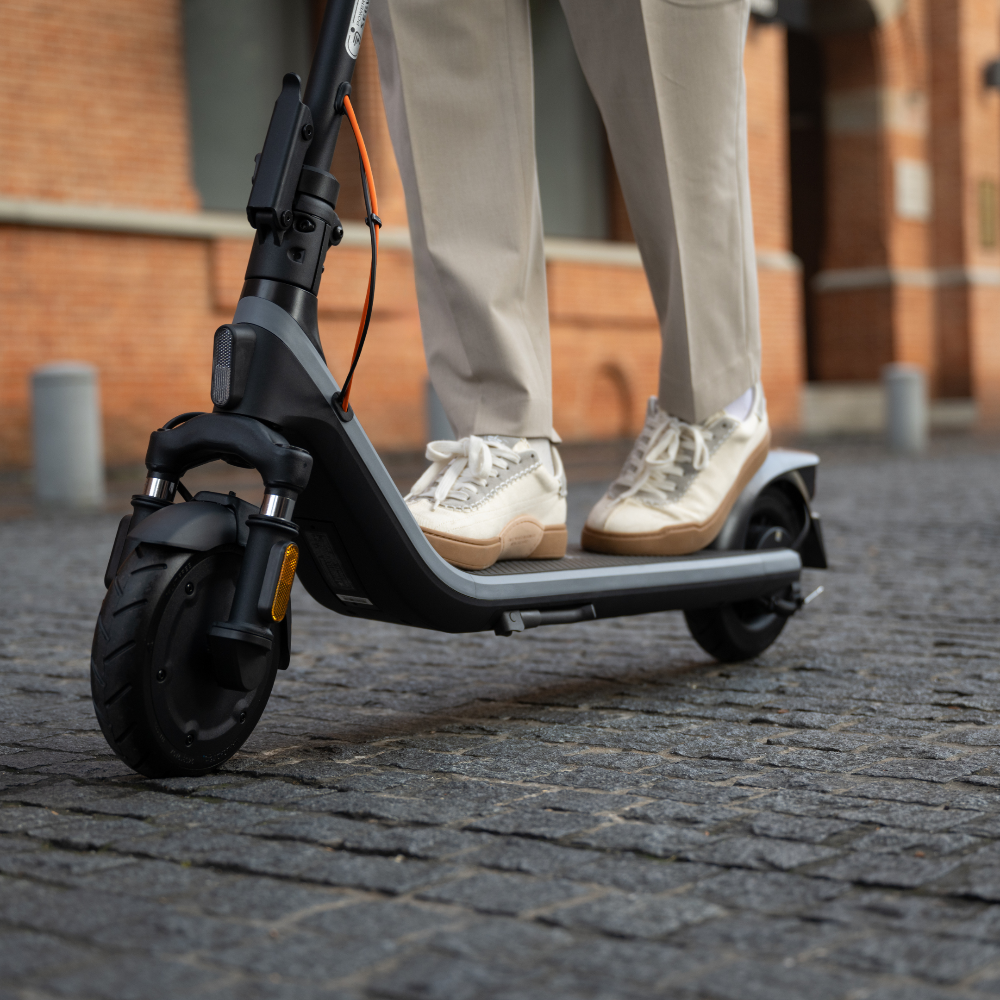 Segway-Ninebot E2 Plus E II Electric KickScooter lifestyle photo of consuming on kickscooter